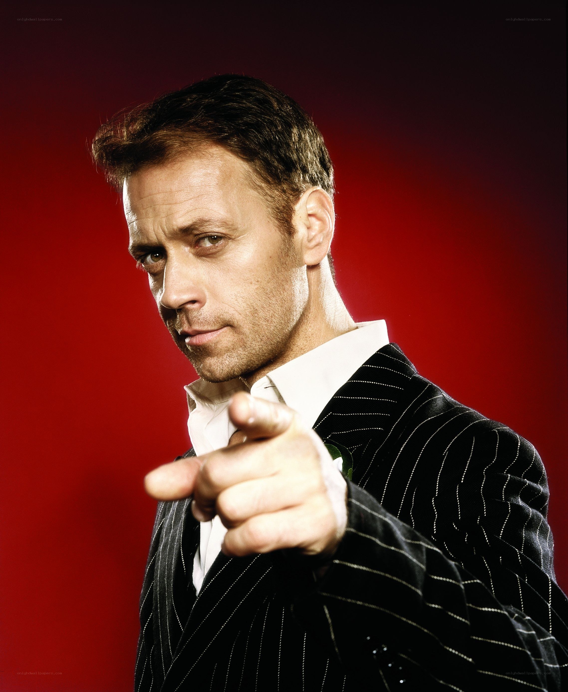 Man in pinstripe suit pointing