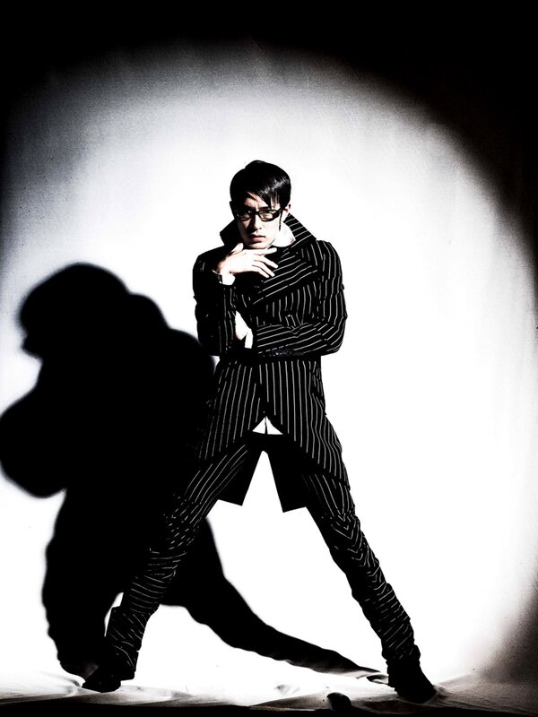 man in pinstripe suit posing