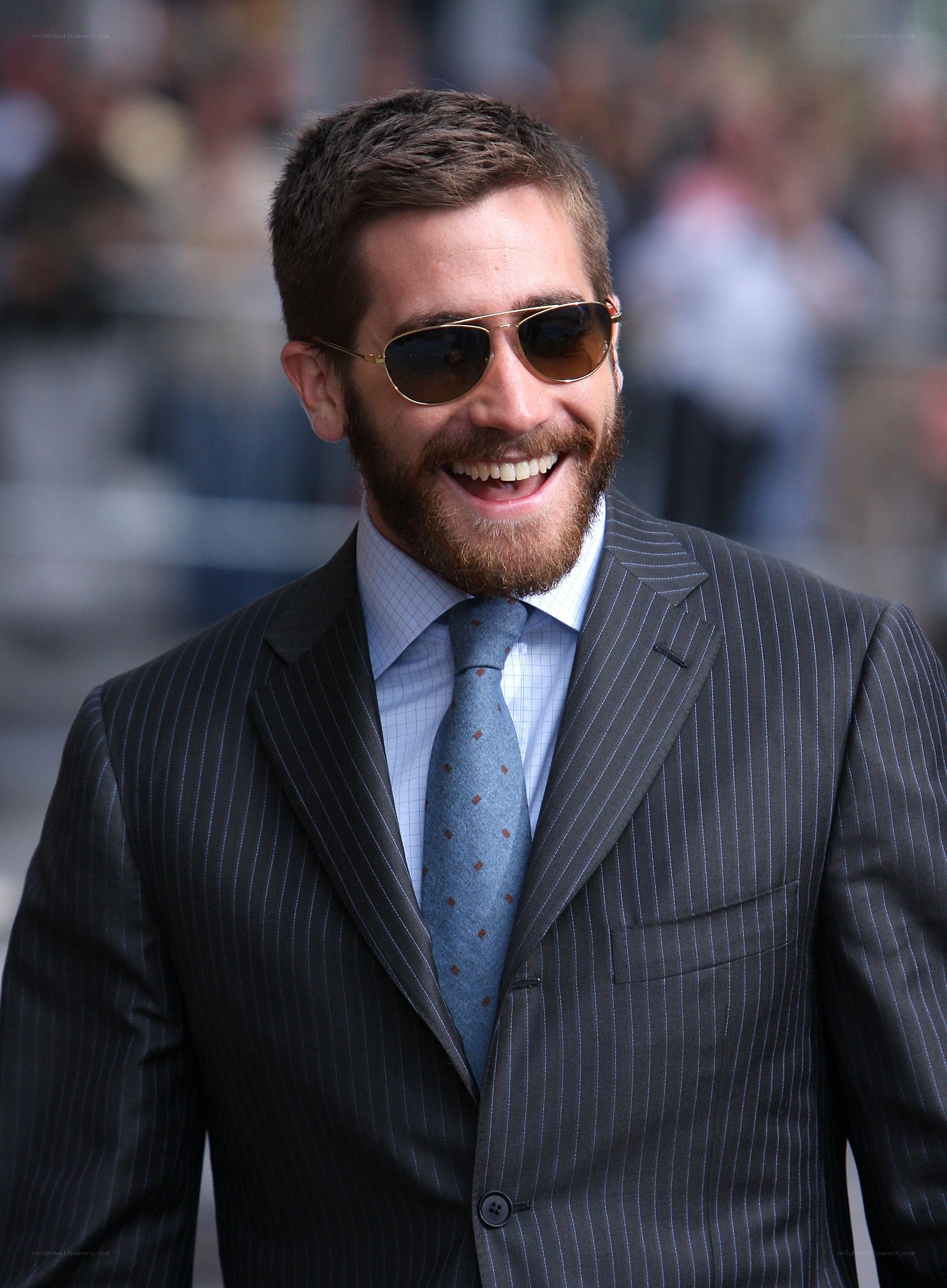 man in pinstripe suit smiling