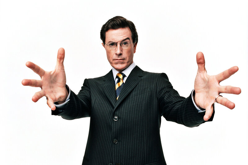 Man in pinstripe suit with hands out