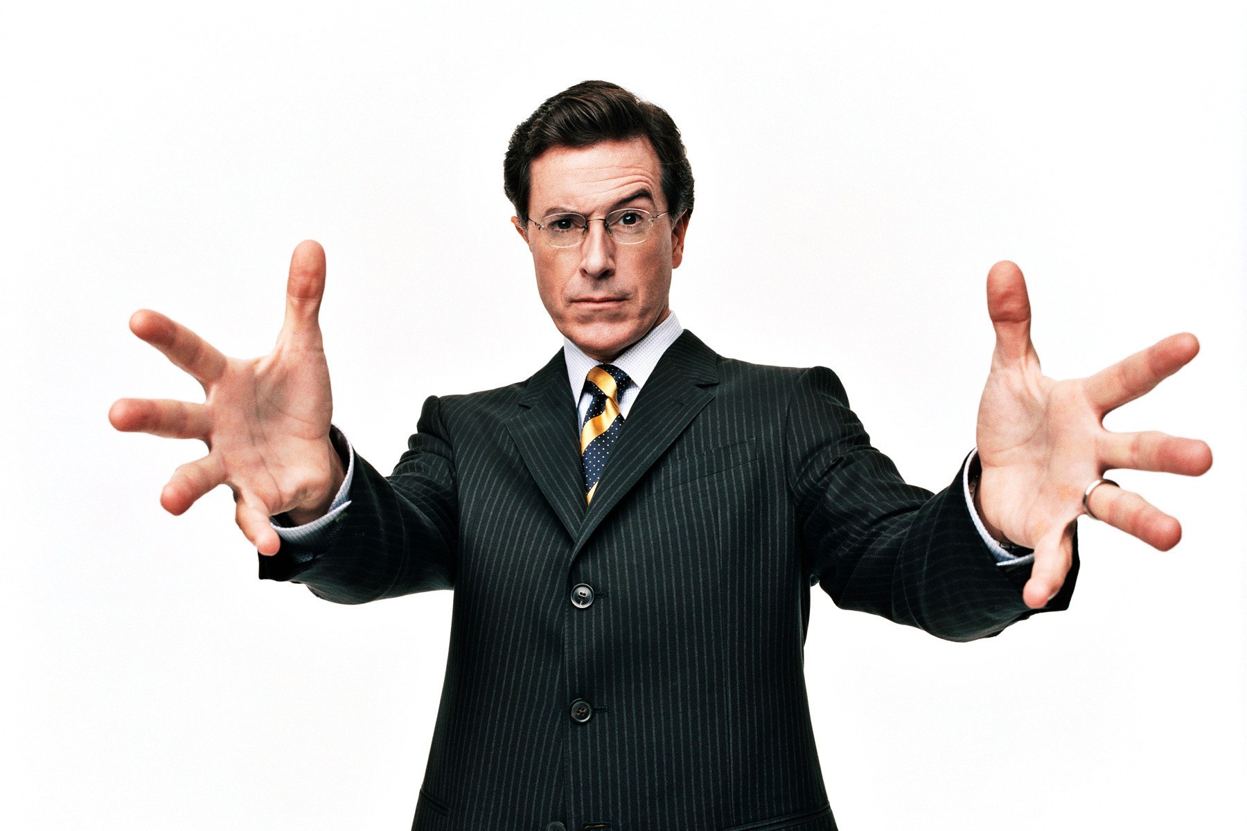 Man in pinstripe suit with hands out