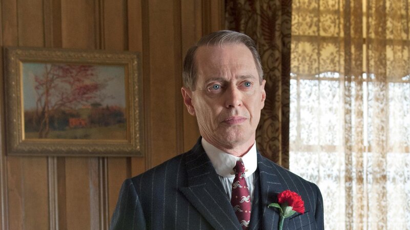 Man in pinstripe suit with red flower
