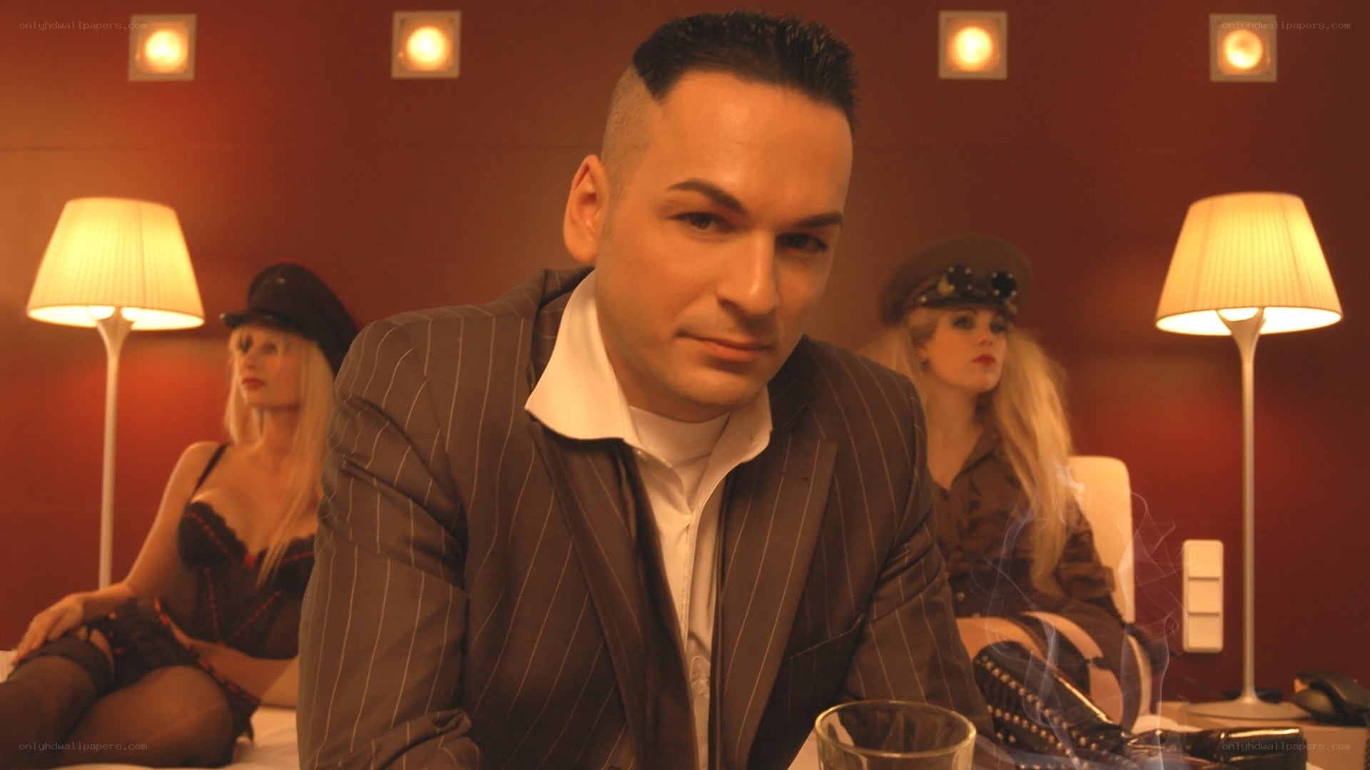 Man in pinstripe suit with women in background