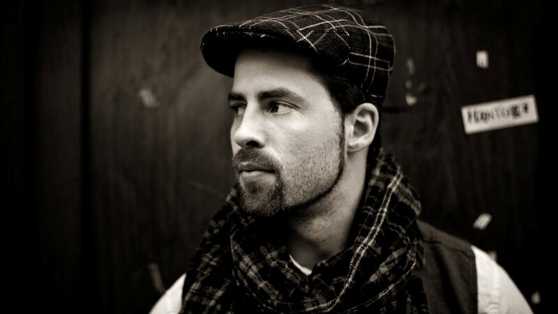 man in plaid hat and scarf