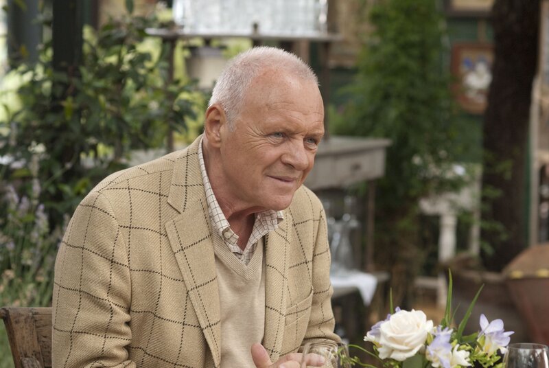 man in plaid jacket at table