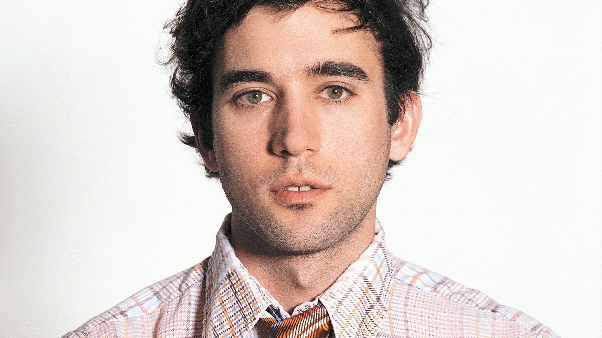 man in plaid shirt and tie