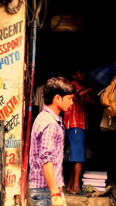 man in plaid shirt at shop entrance