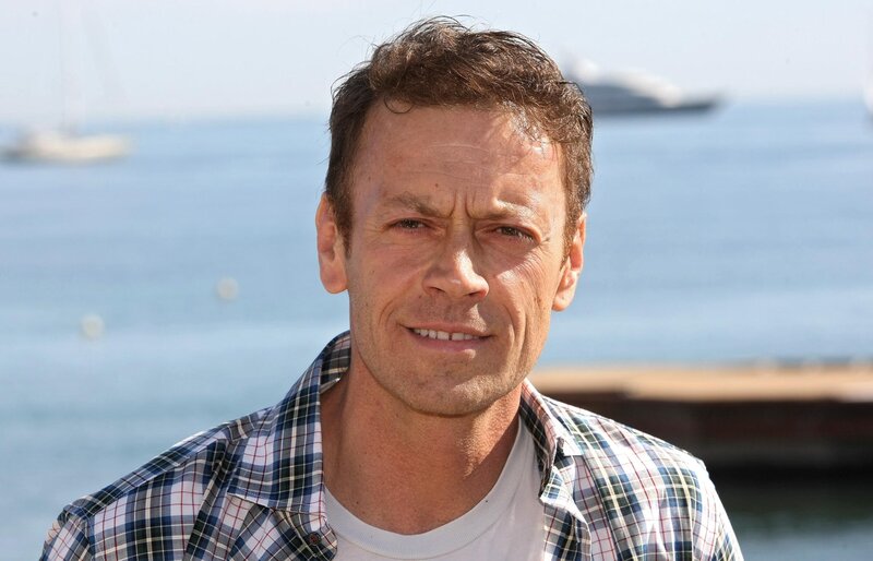 man in plaid shirt by the sea