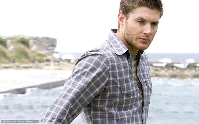 man in plaid shirt by the sea