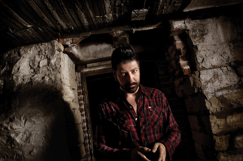 man in plaid shirt in old room