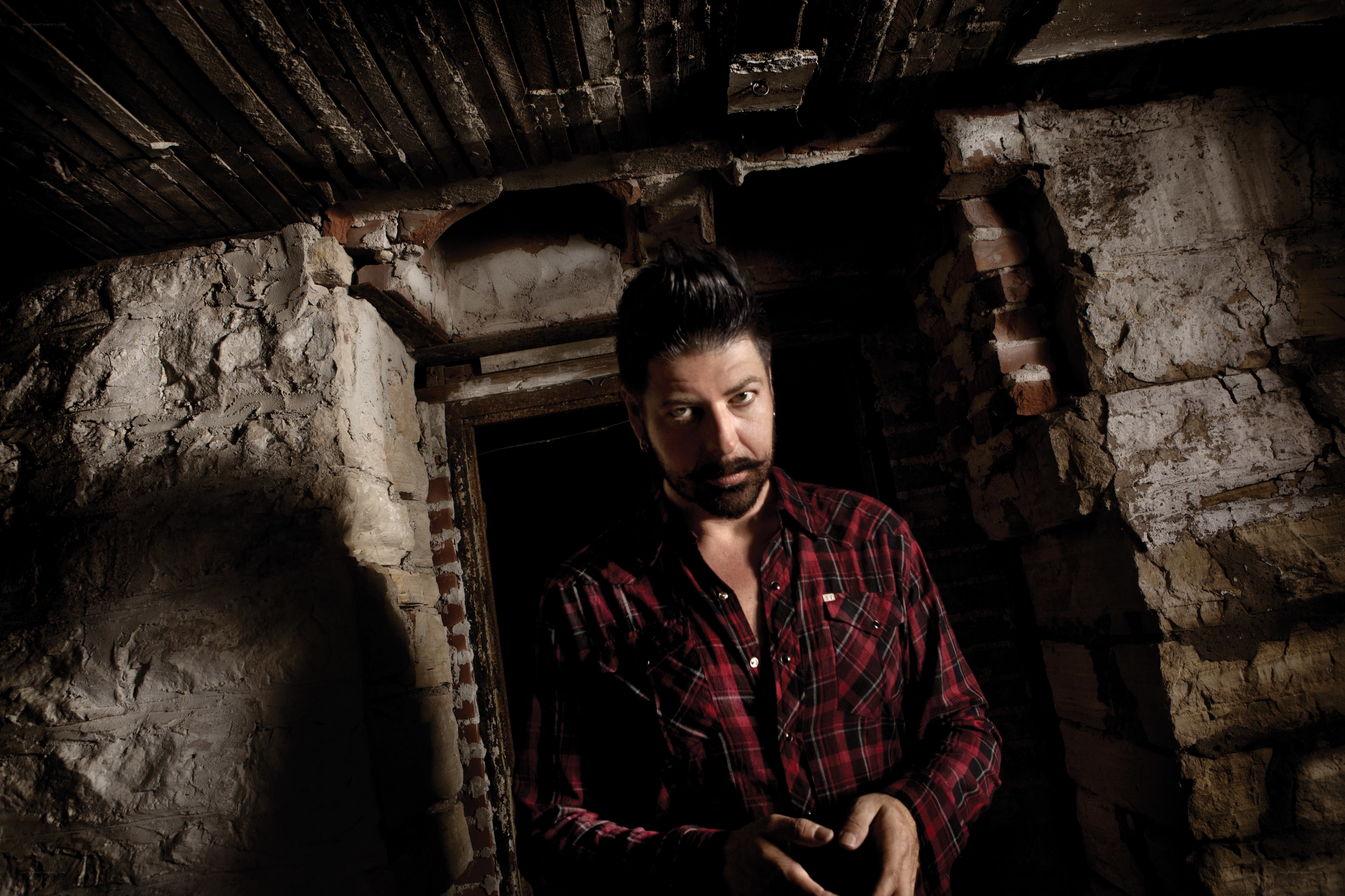 man in plaid shirt in old room