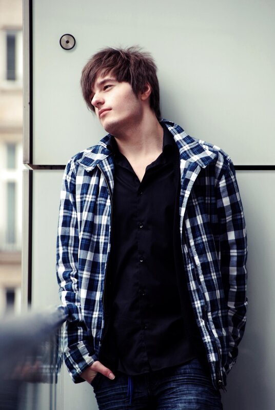 man in plaid shirt leaning