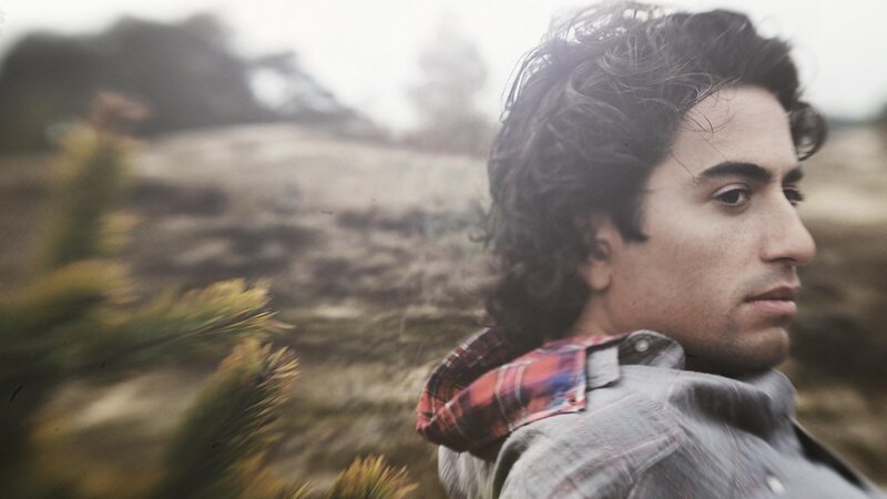 man in plaid shirt outdoors
