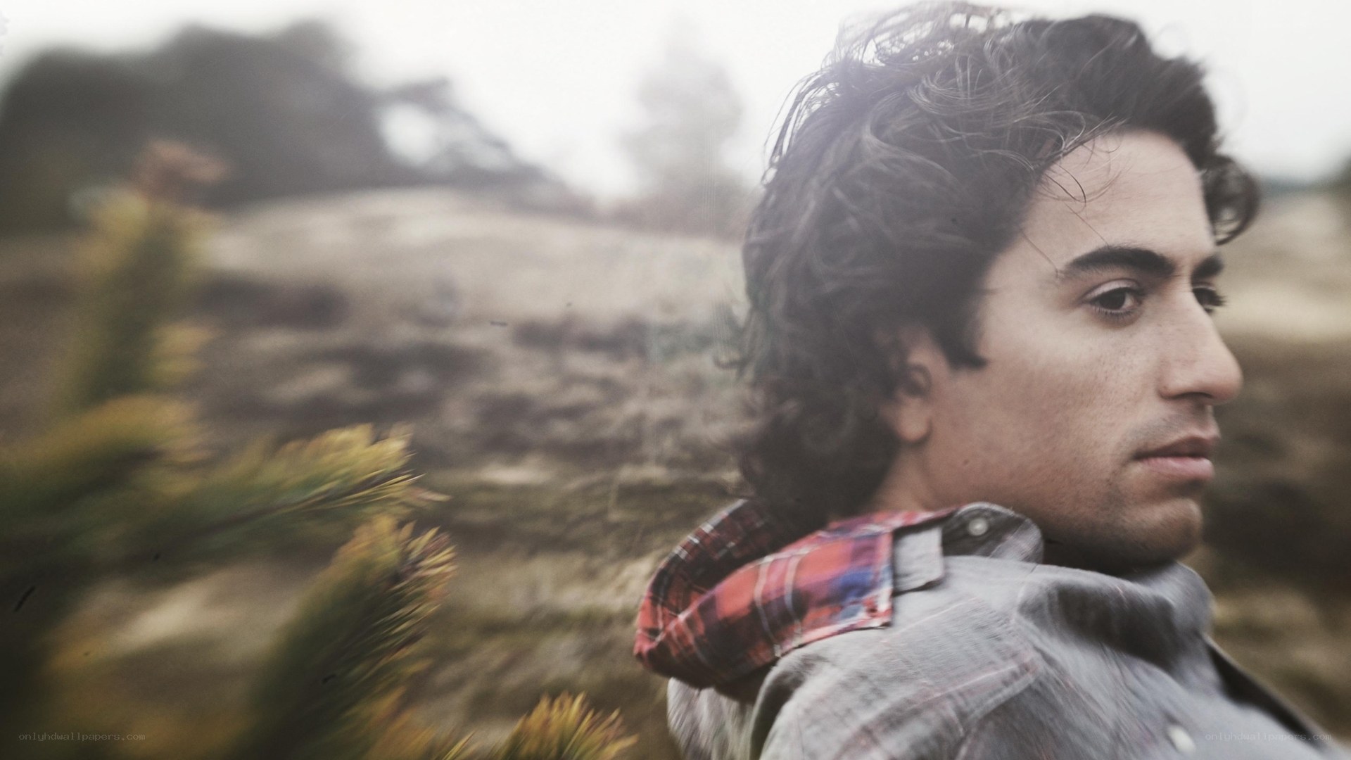 man in plaid shirt outdoors