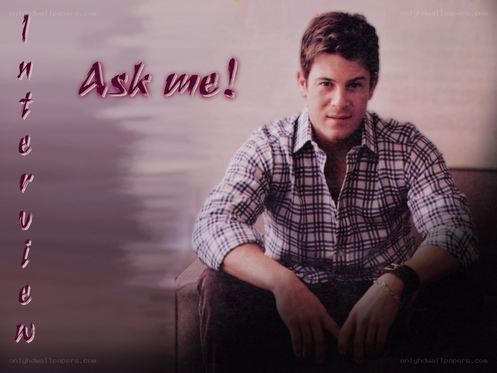 man in plaid shirt sitting