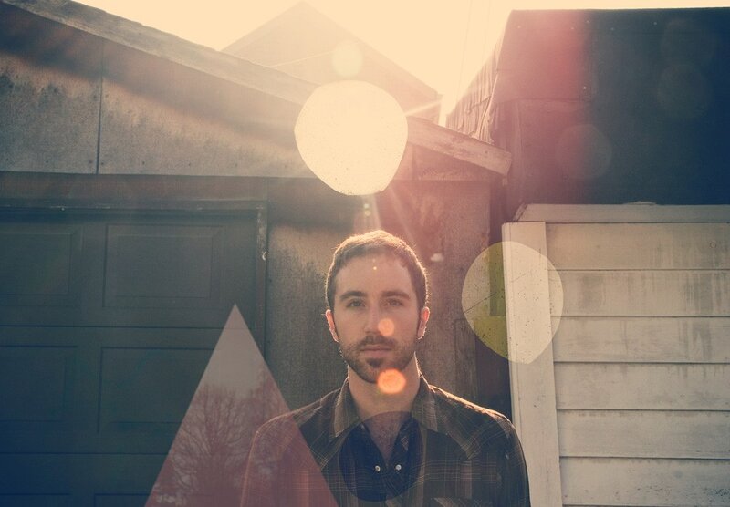 man in plaid shirt with lens flare