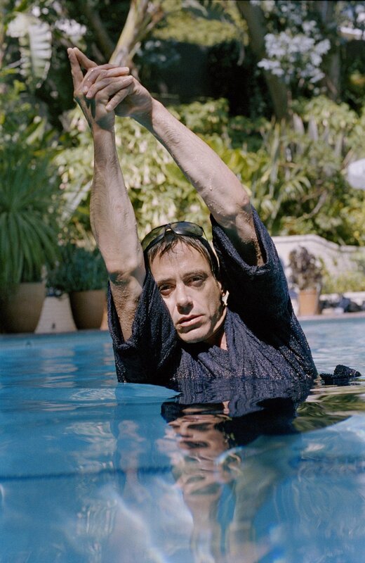 man in pool with towel