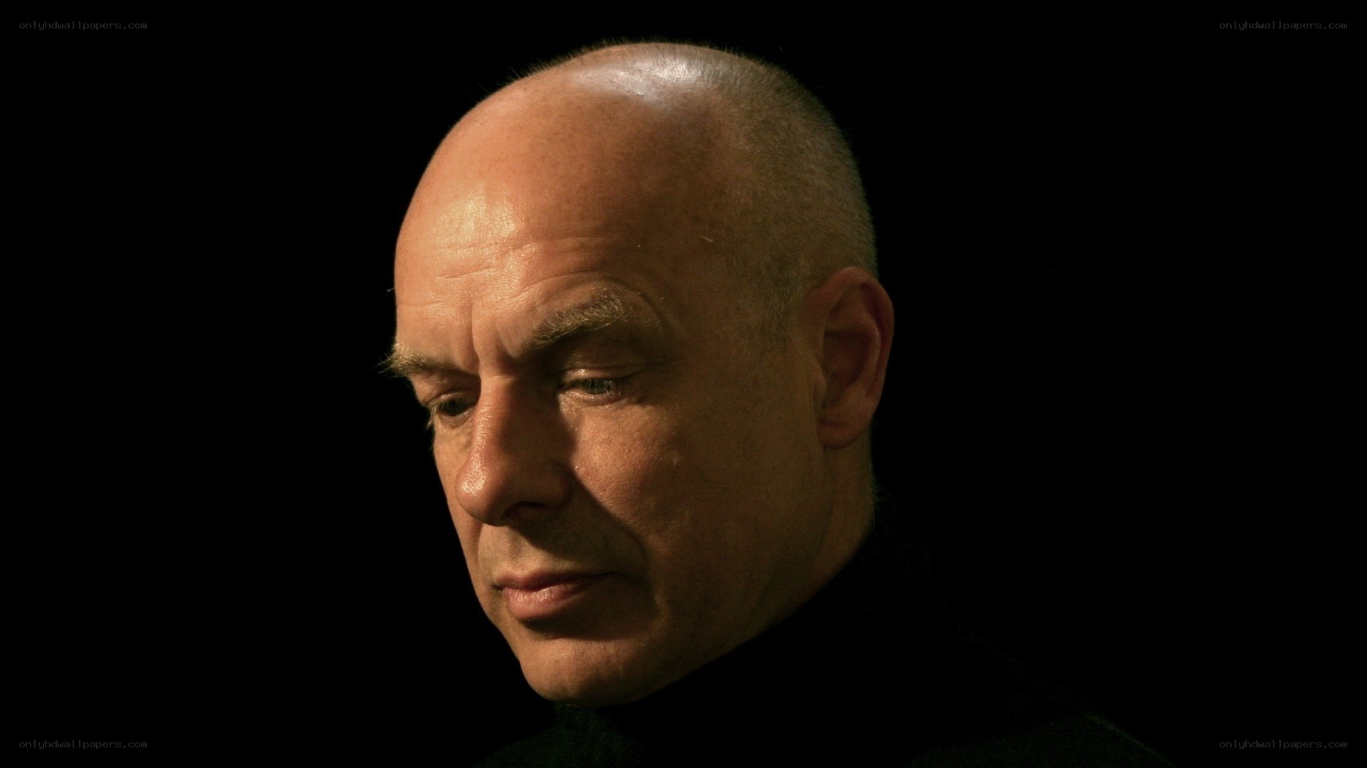 man in profile against black background