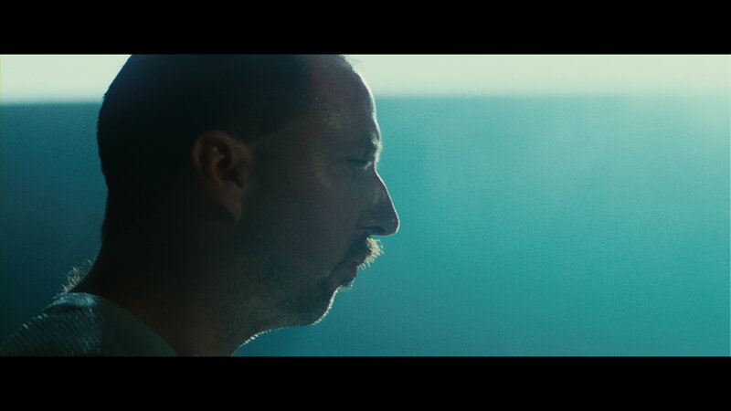 man in profile against blue light