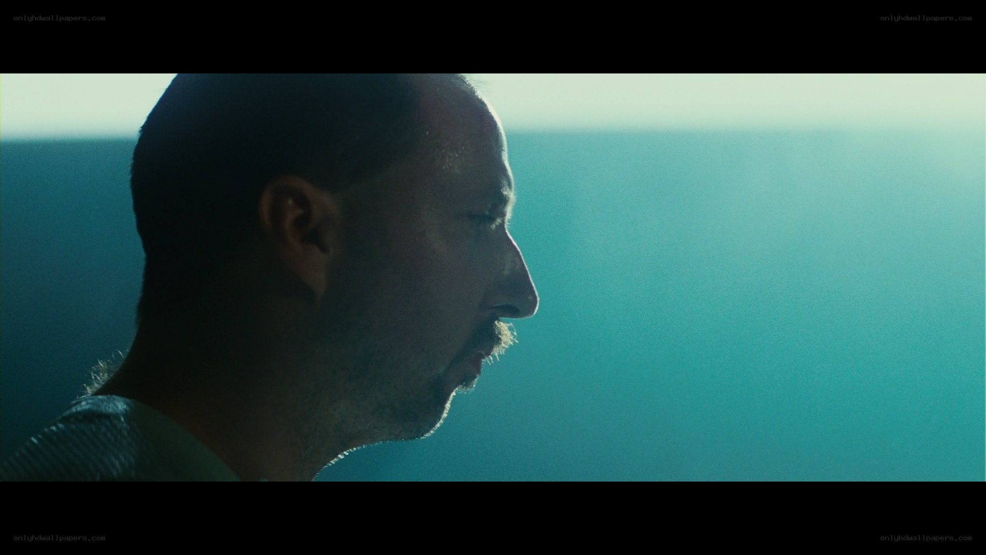 man in profile against blue light