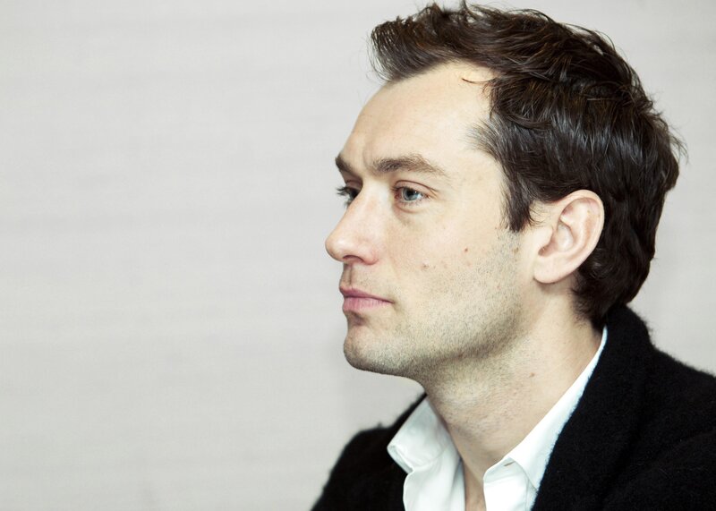 man in profile wearing black coat