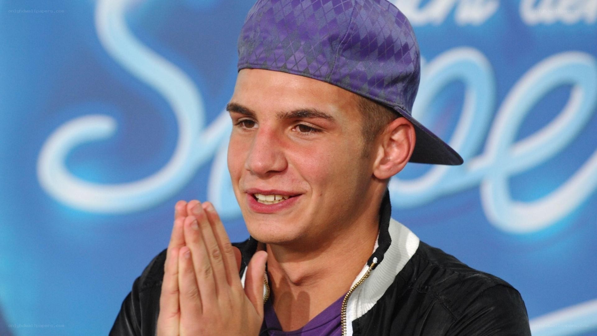 man in purple cap smiling