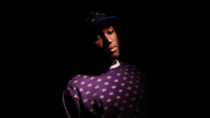 man in purple crown sweater
