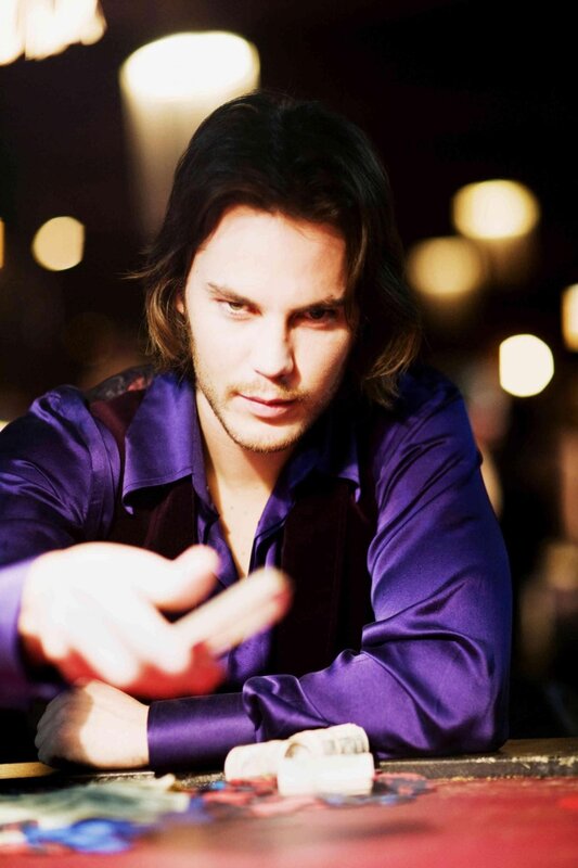 man in purple shirt at table