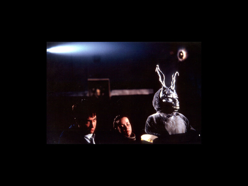 Man in rabbit costume with two people