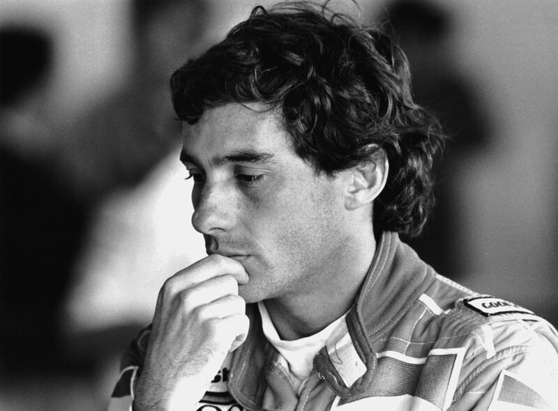 man in racing suit thinking