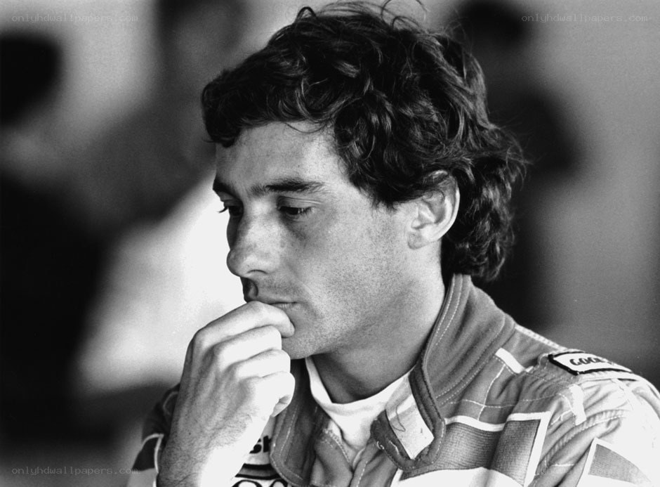 man in racing suit thinking