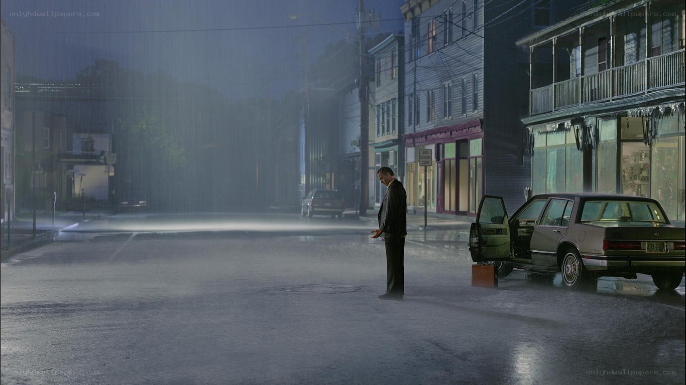 man in rain on street