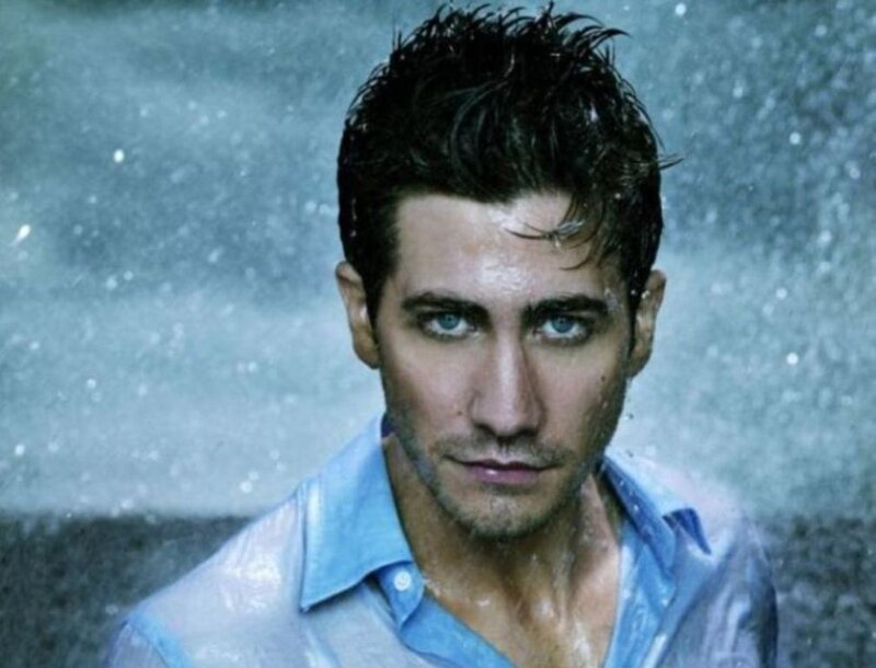 man in rain with blue shirt