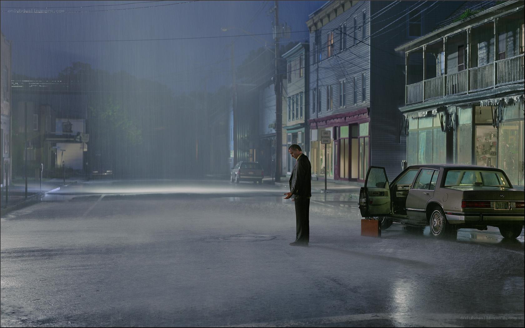 Man in rain with car