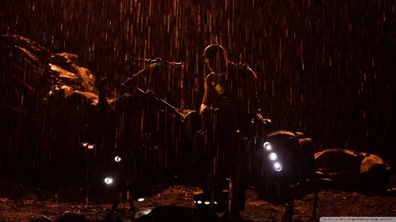 man in rain with motorcycle