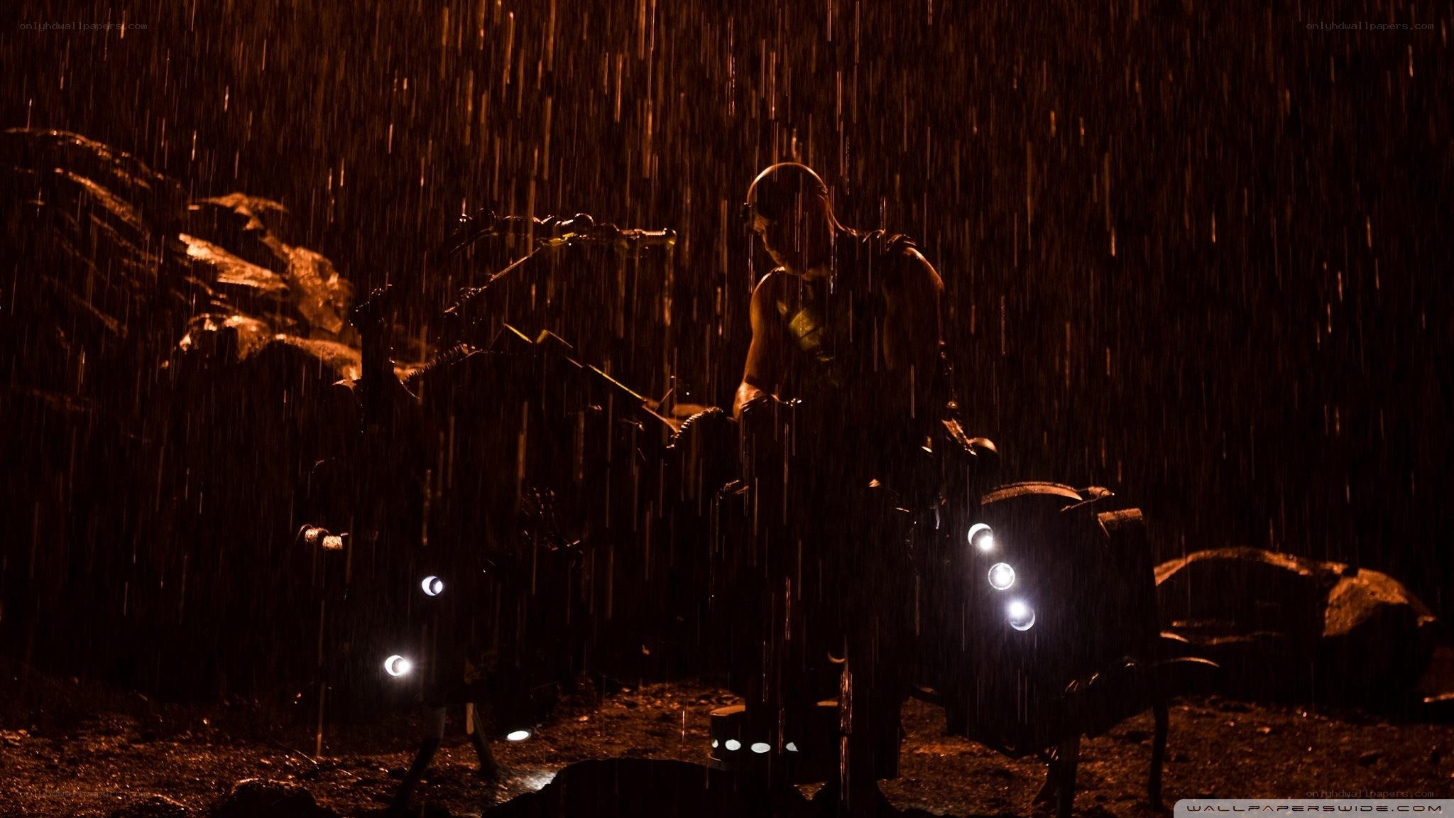 man in rain with motorcycle