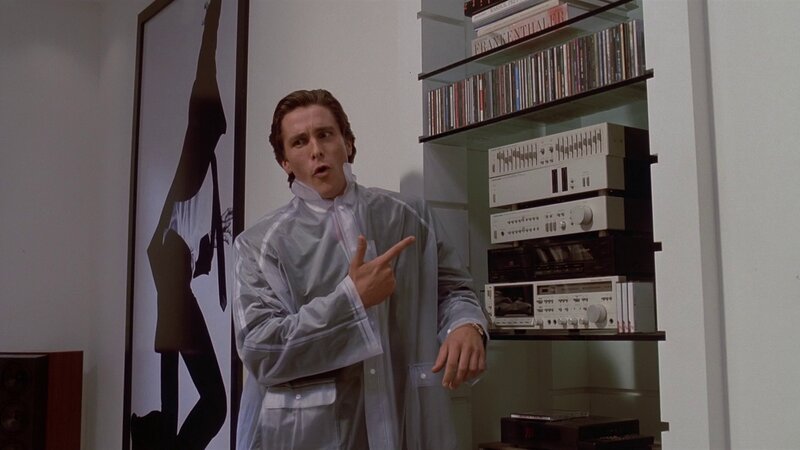 man in raincoat pointing