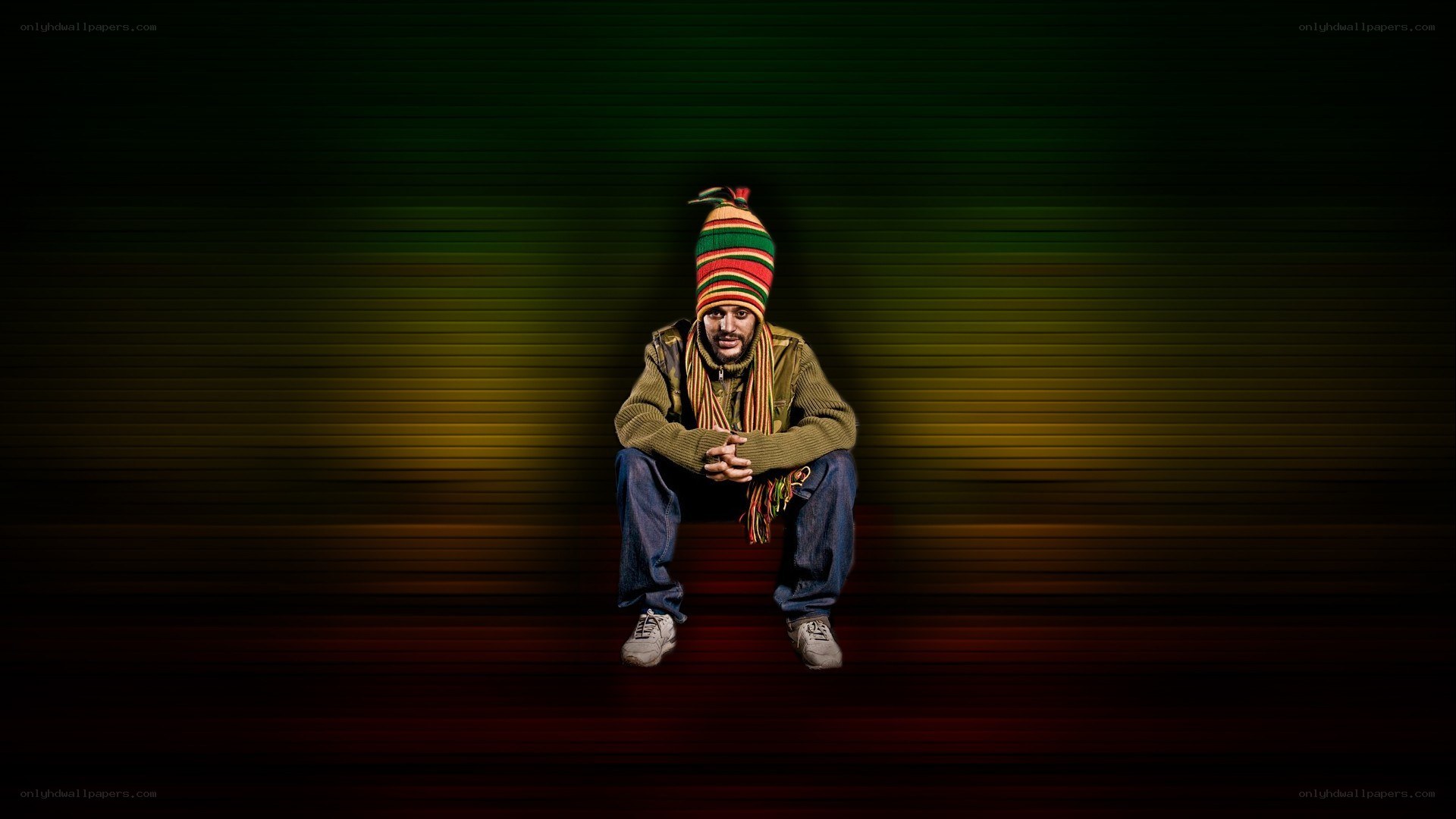 man in rasta hat sitting