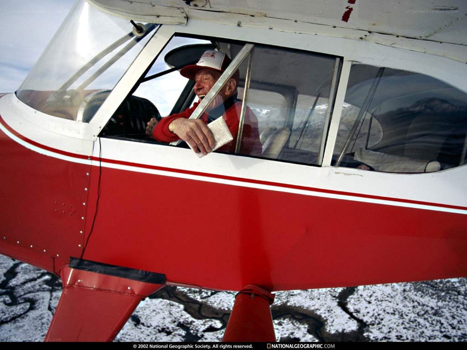Man in red airplane cockpit