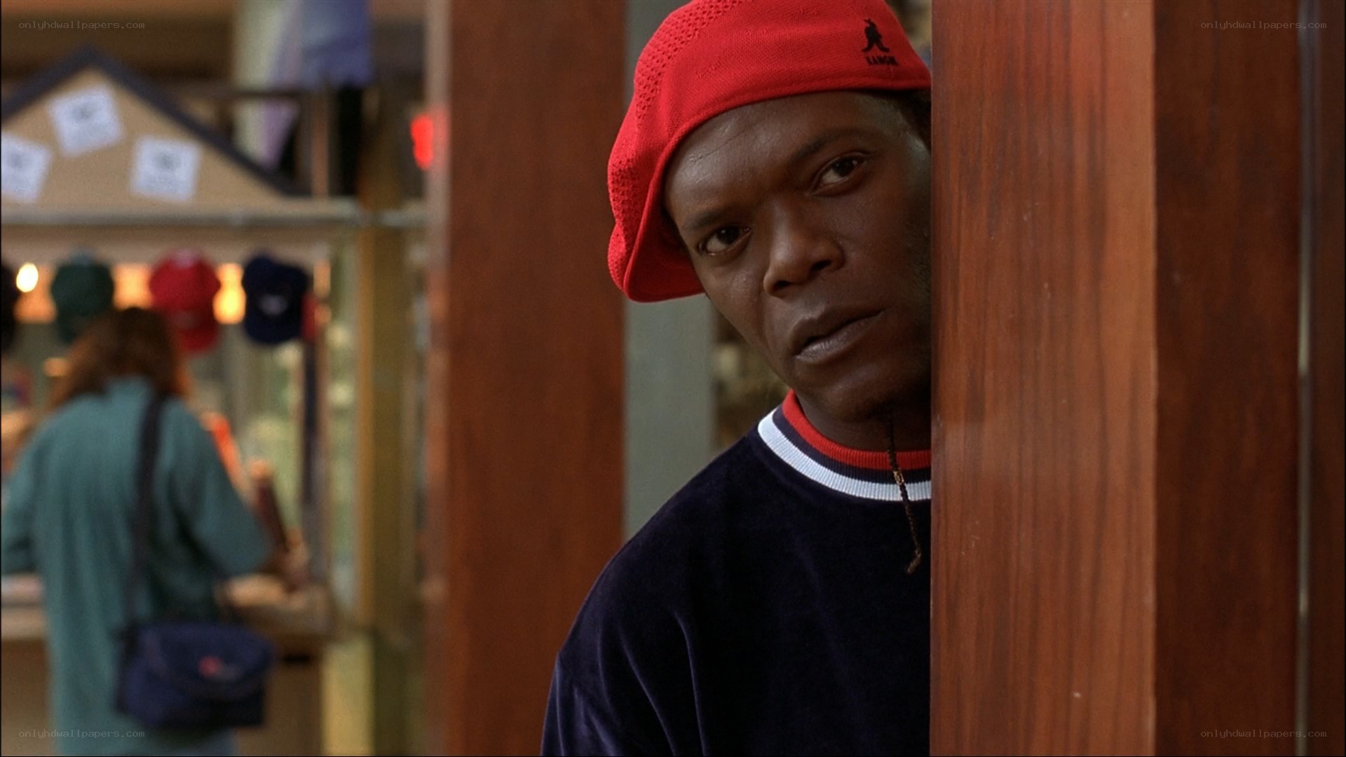 man in red cap peeking