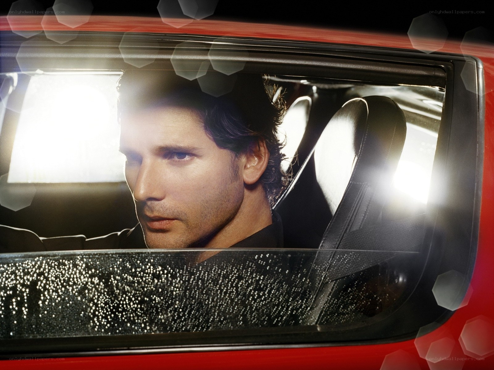 man in red car at night