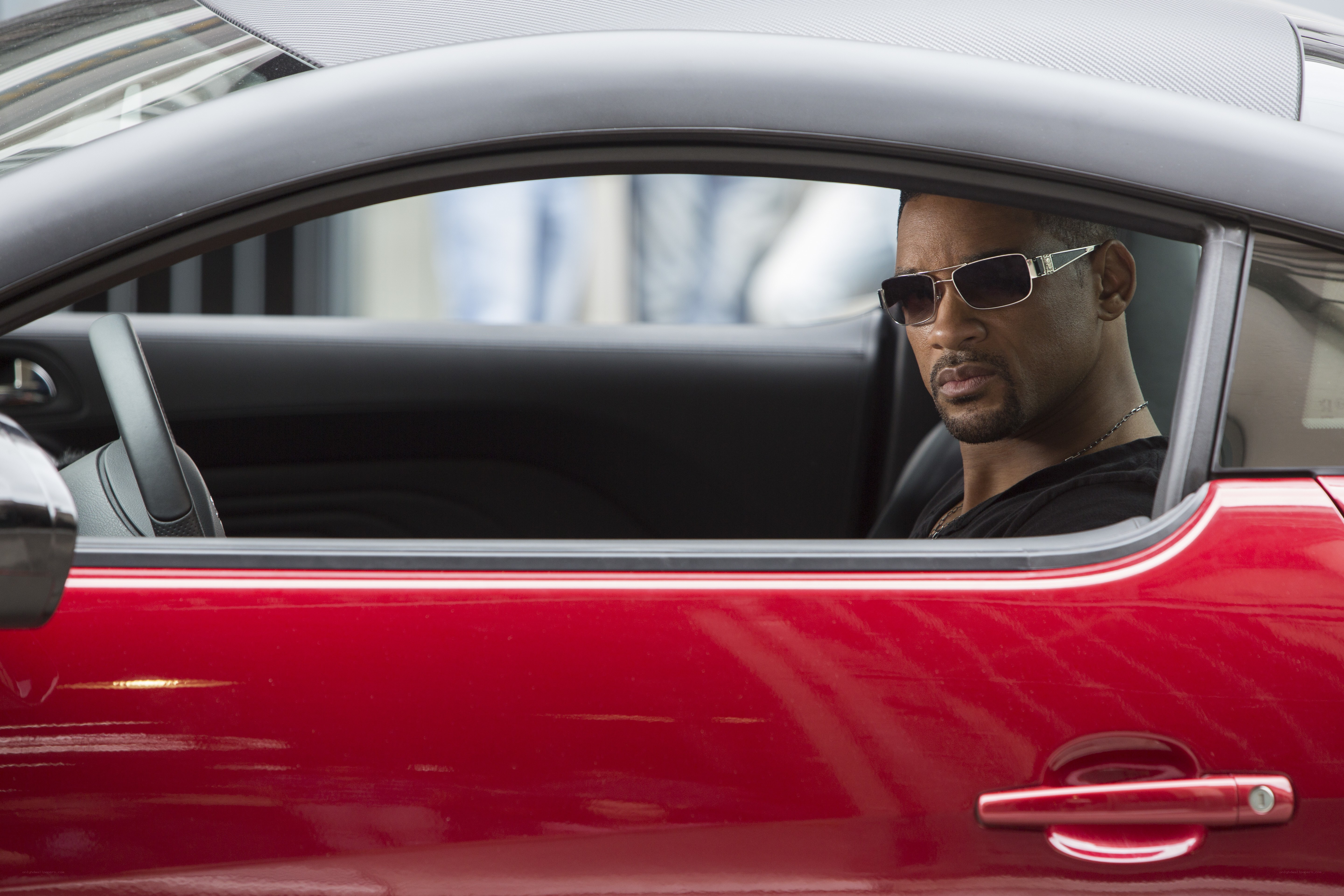 man in red car wearing sunglasses