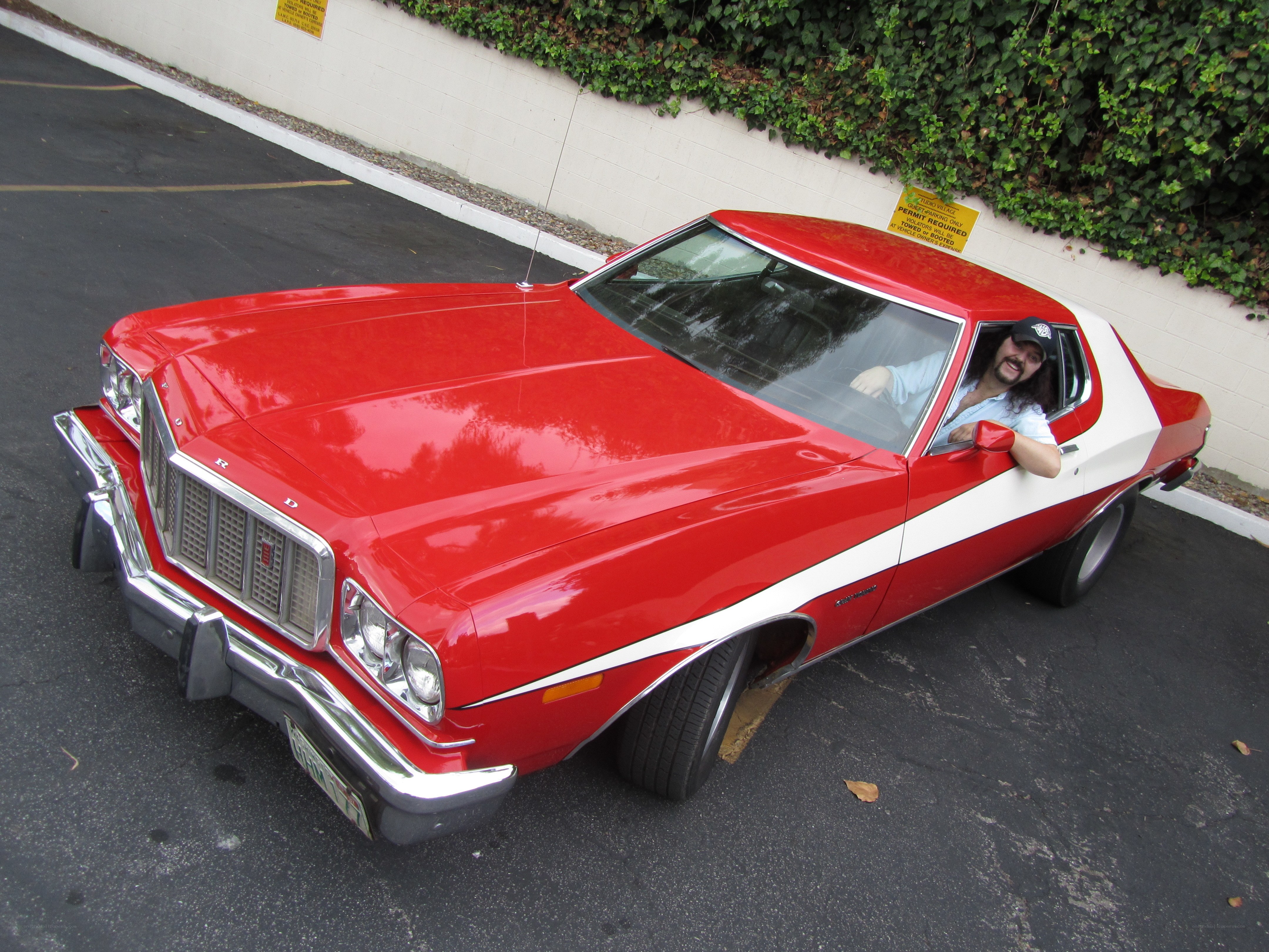 Man in red classic car