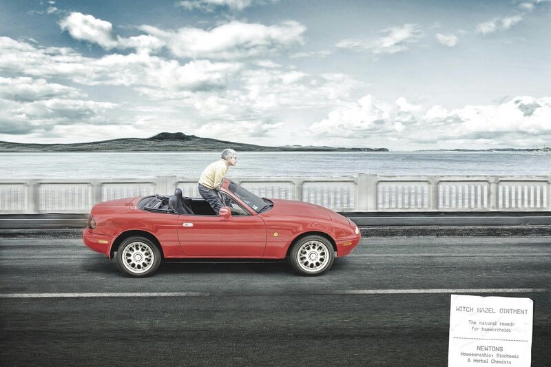 Man in red convertible car