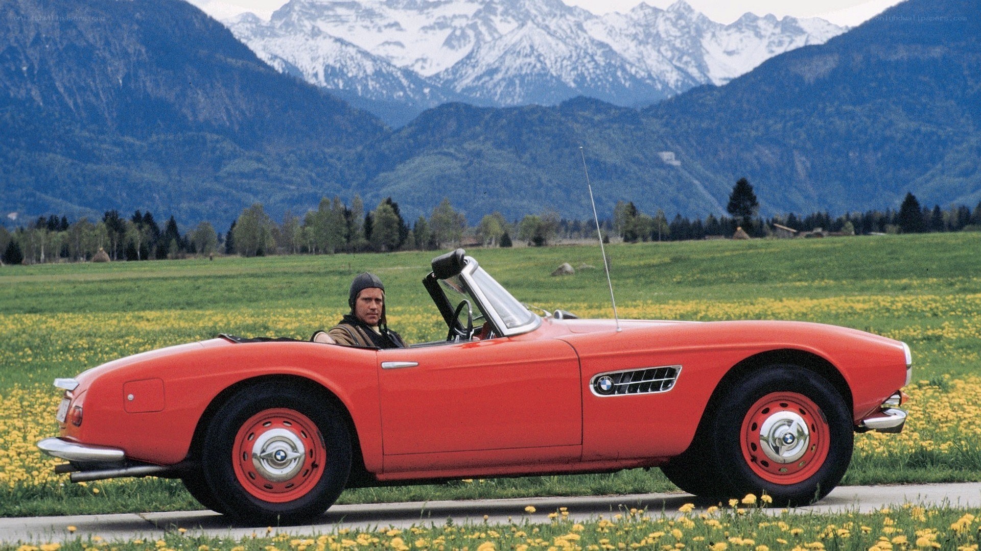 Man in red convertible car