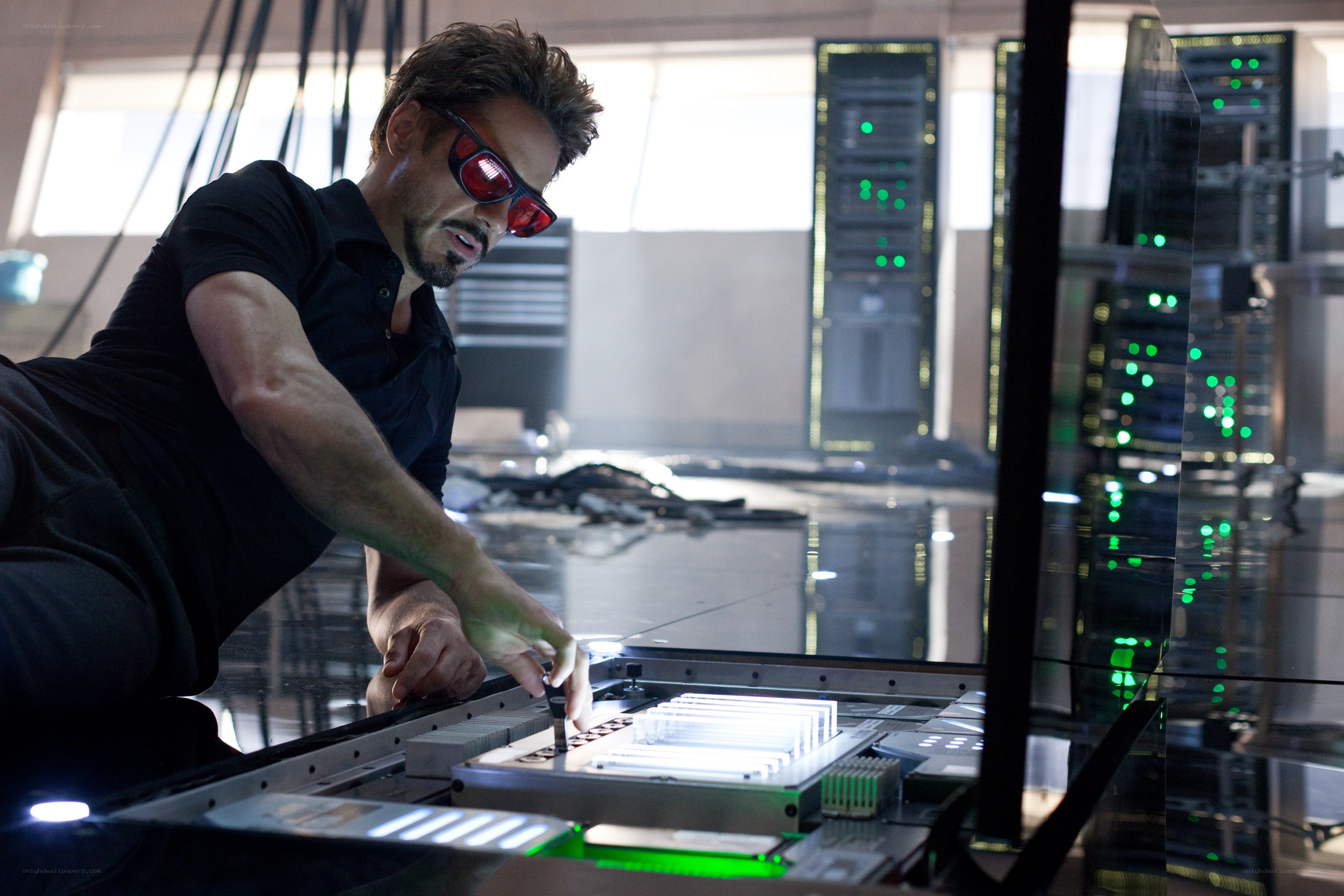 man in red glasses working on tech