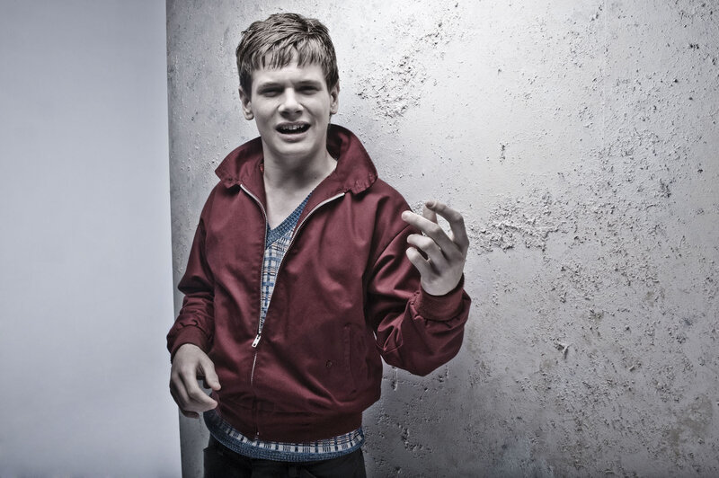 man in red jacket against wall