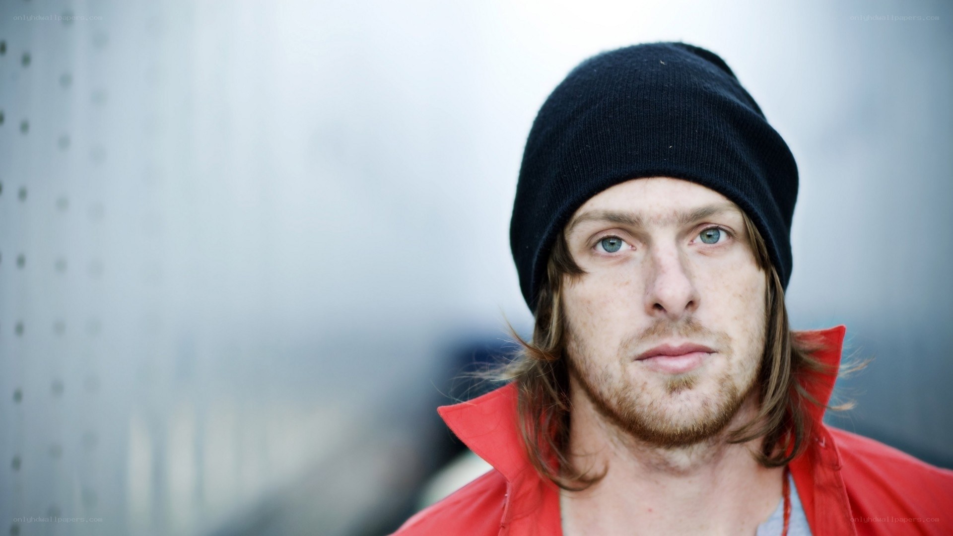 man in red jacket and beanie