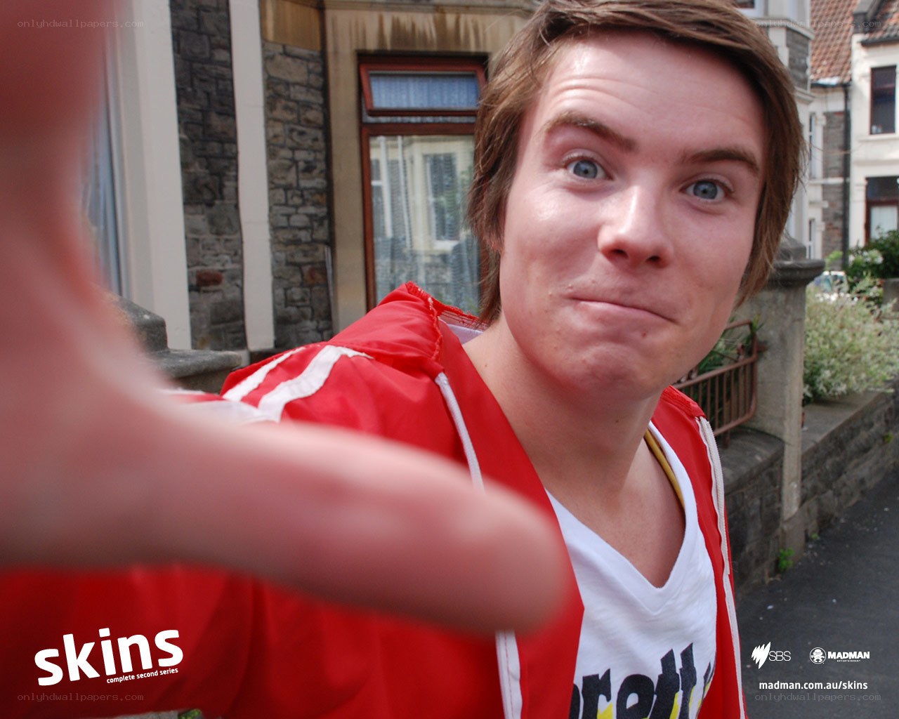 man in red jacket taking selfie