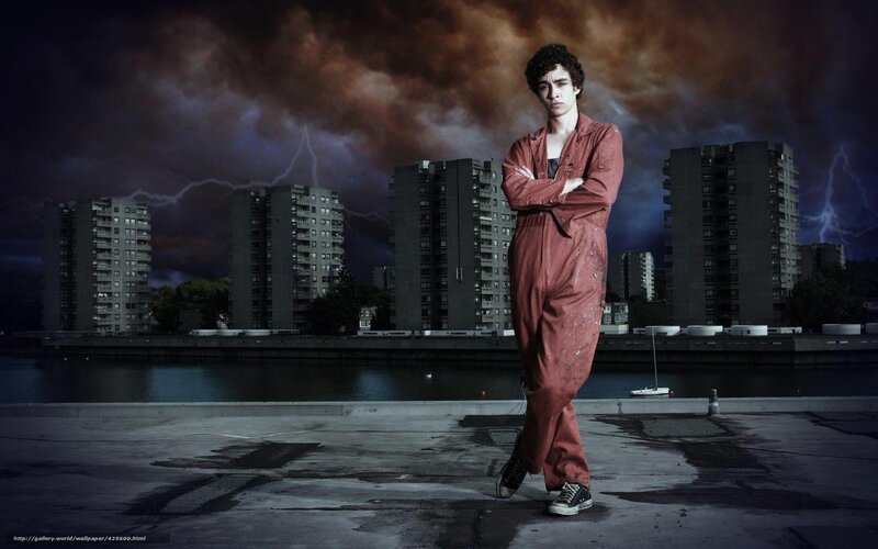 man in red overalls on rooftop